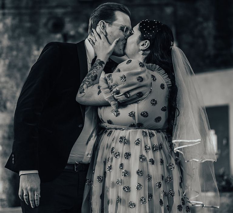 Bride & groom kiss in black & white image after Old Marylebone Town Hall wedding ceremony