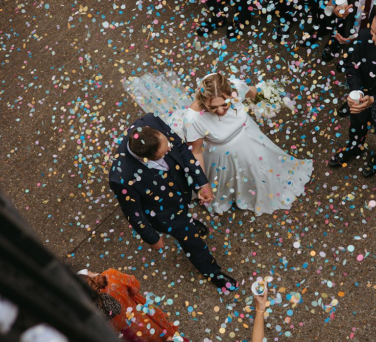 Colourful confetti from Flutter, Darling! falls over the couple 