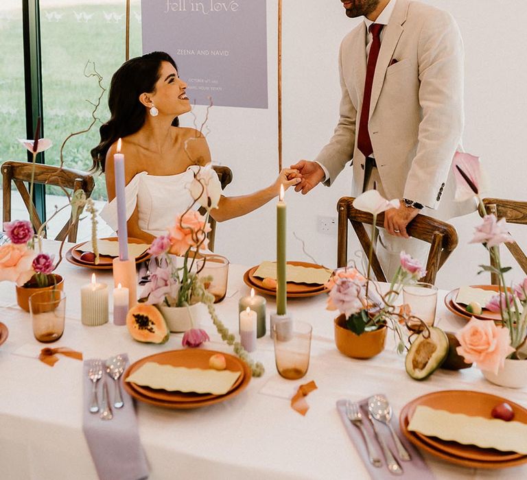 Bride and groom go to sit for their wedding reception with a lavender, rust and green colour palette 