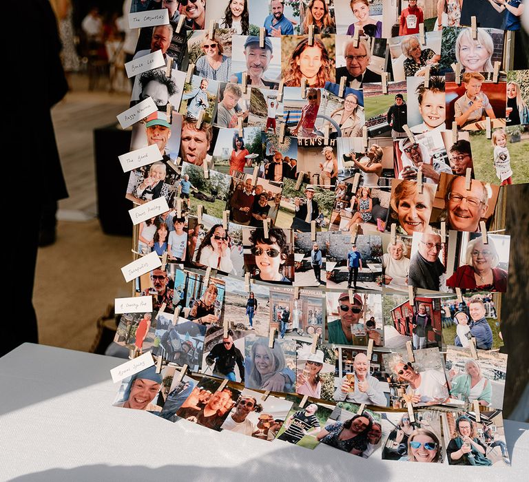 DIY seating plan complete with pictures of wedding guests and white pegs