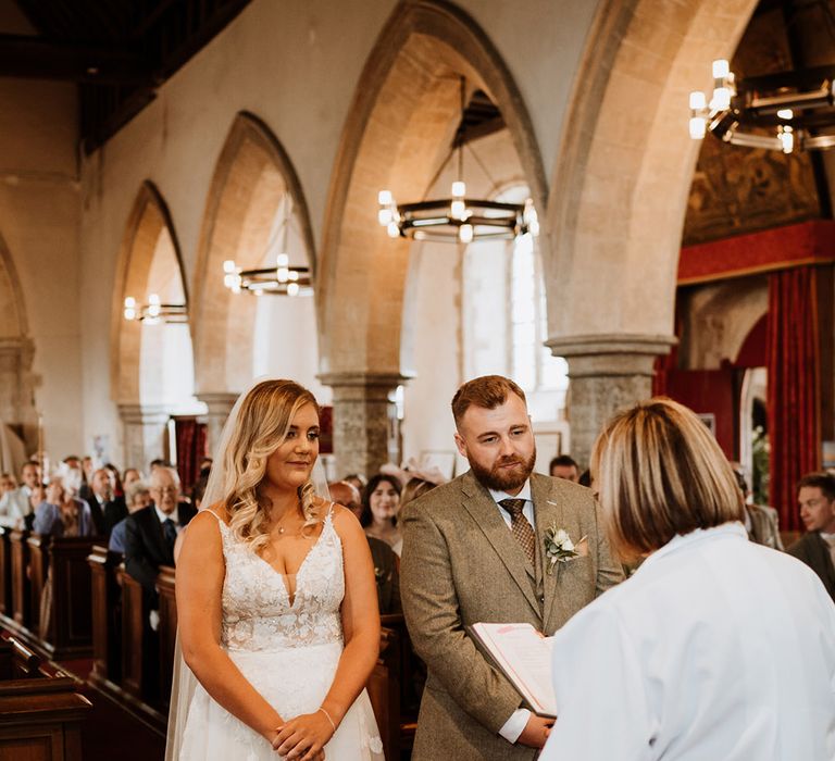 The bride and groom participate in a traditional church wedding ceremony 