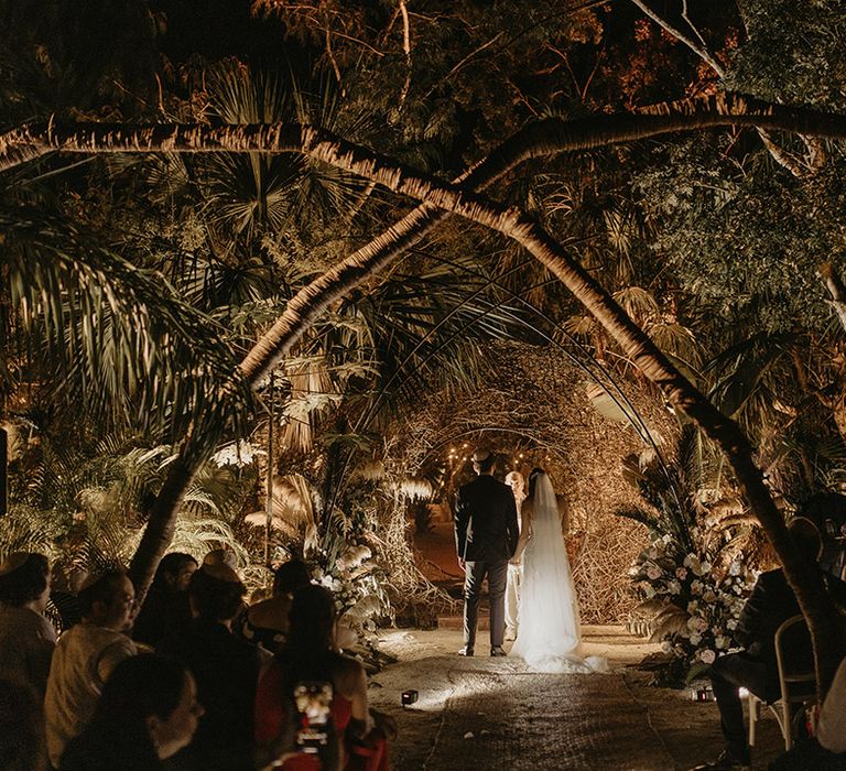 Bride & groom marry in the jungle surrounded by trees during cenote wedding in Tulum