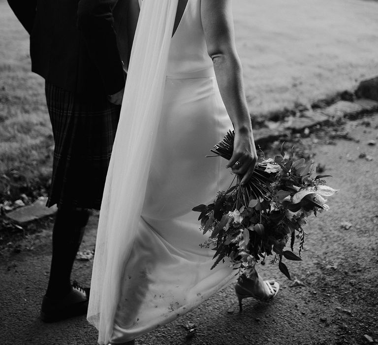 Bride wears cathedral veil in her loosely curled blonde hair