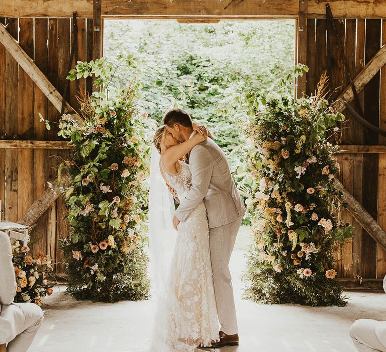 Rustic barn wedding at Nancarrow Farm with the bride and groom sharing their first kiss as a married couple 