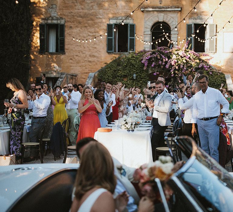 Bride & groom arrive in vintage wedding car 