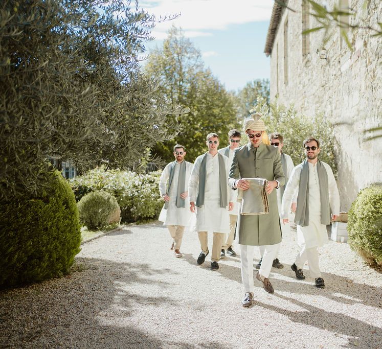 Groom and groomsmen in cream and green Sherwani and Churidar outfits at Provence wedding 