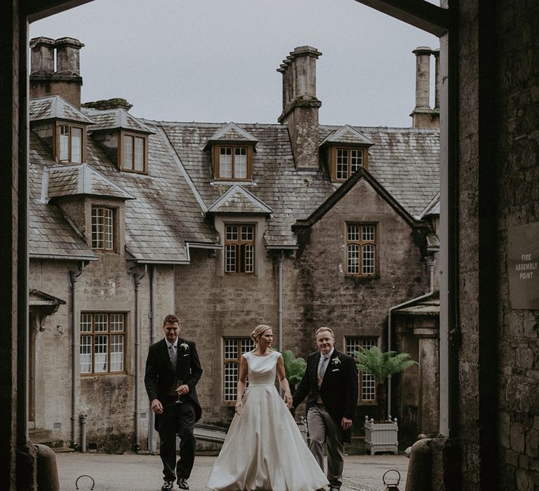 The bride and groom walk around the Hotel Endsleigh wedding venue in Devon 