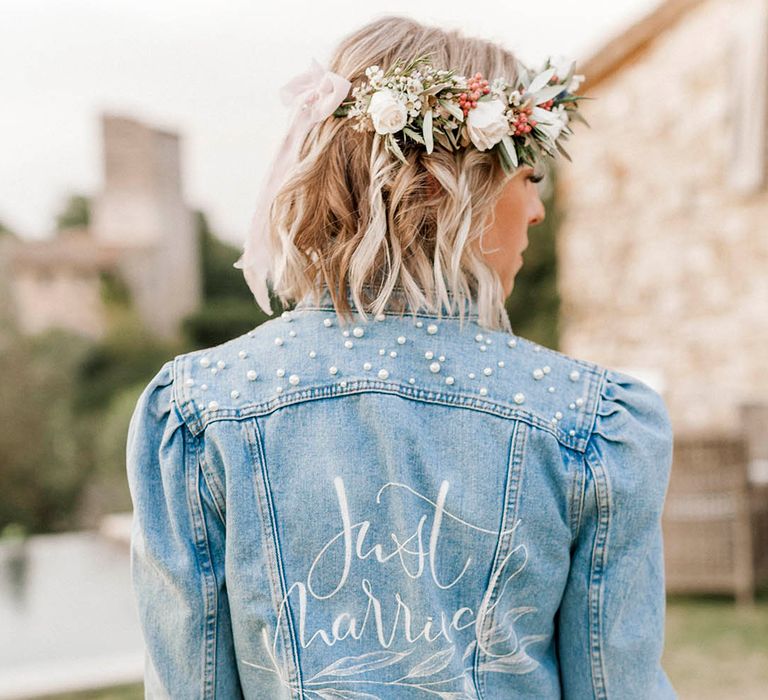 Bride in light blue denim jacket with puff sleeves with small pearls on the top of the bridal denim jacket 