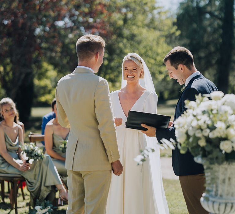 Bride and groom exchanging wedding vows at outdoor destination wedding in a chateau 