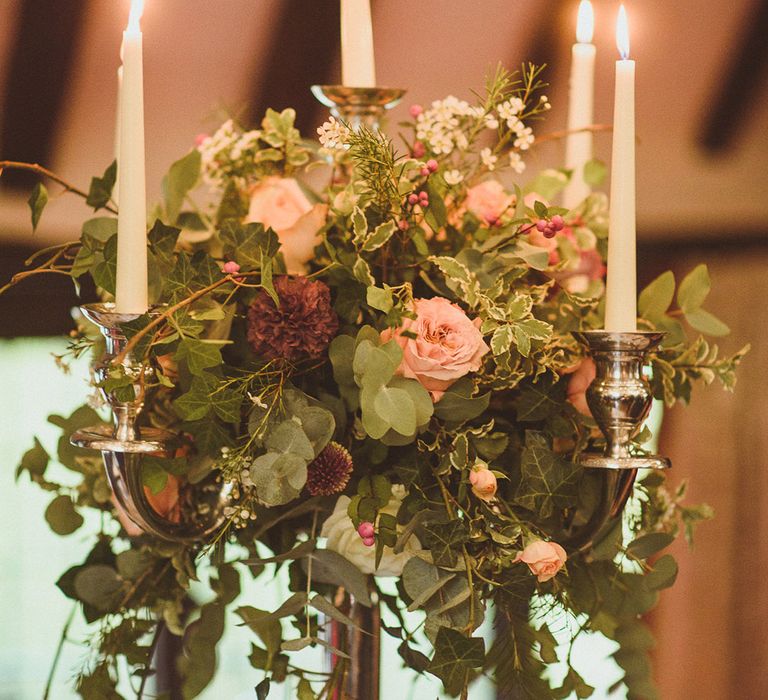 Tall candelabra wedding table centrepiece with autumnal wedding flowers 