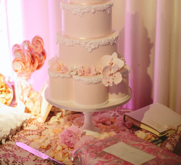 Pale pink retro wedding cake with flower shaped layer with pink and white frosting 