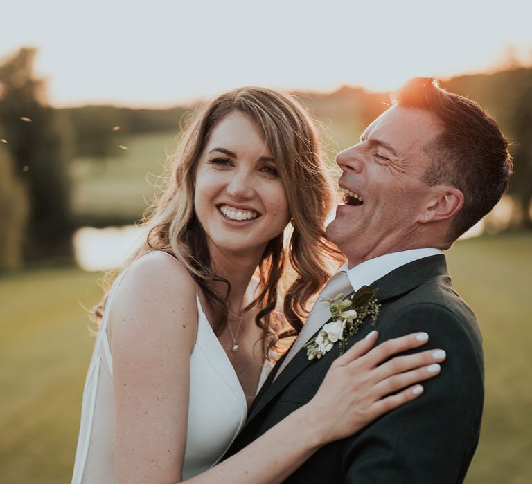 Bride and groom posing for cute couple photos during golden hour 