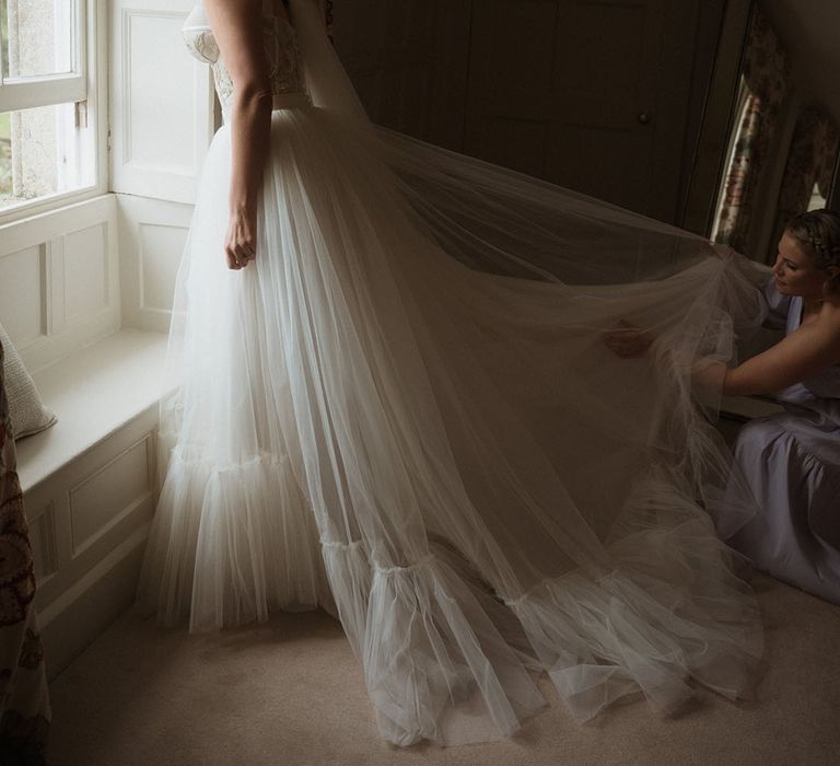 Bride in stunning tulle wedding dress with corset style top 