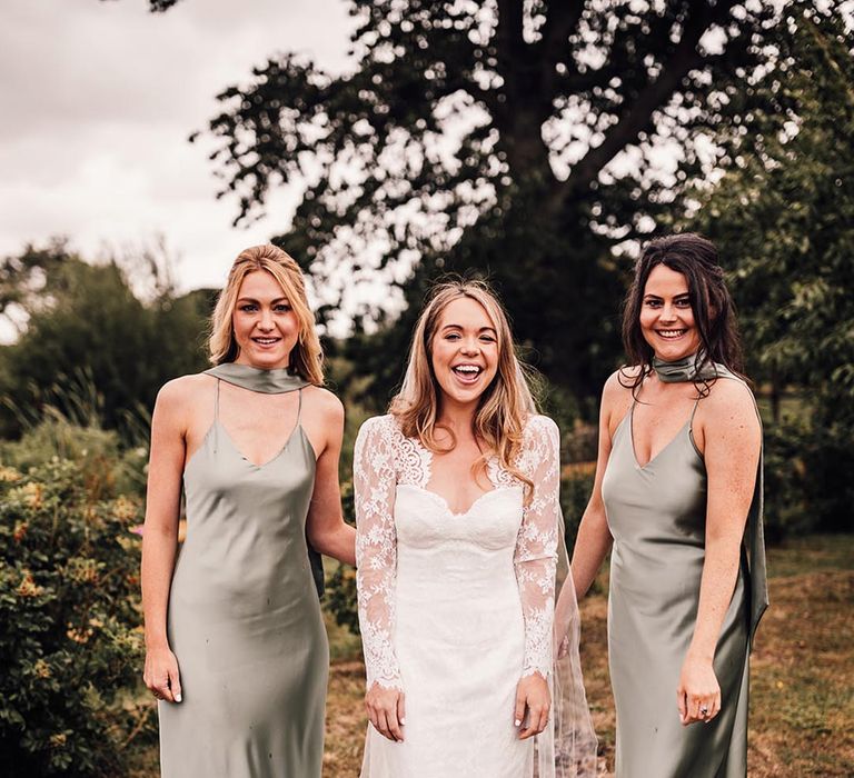 Bridal party wearing green satin bridesmaid dresses for barn wedding 