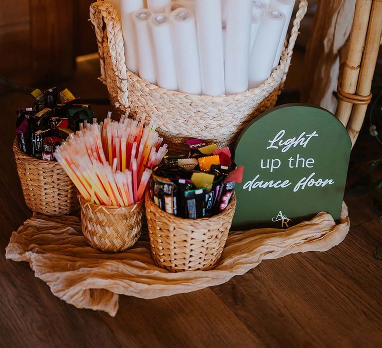 Glow stick station for wedding reception to get guests in the party mood with green signage 