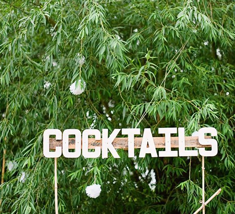 Image of cocktail sign to indicate outdoor wedding bar 