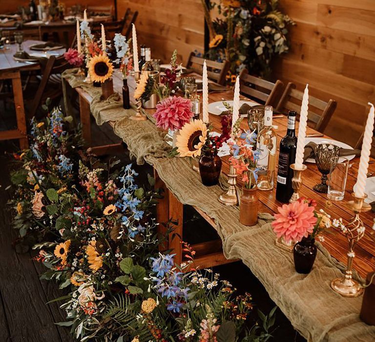 Seasonal summer wedding flowers with colourful table flower arrangements with sunflowers and dahlias 