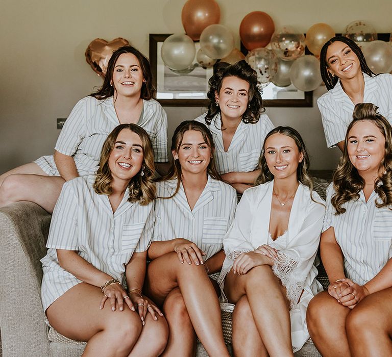 Bridal party getting ready for the wedding wearing matching striped pyjamas 