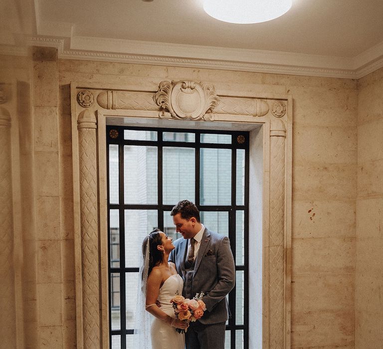 The bride and groom share a kiss at their town hall wedding in London