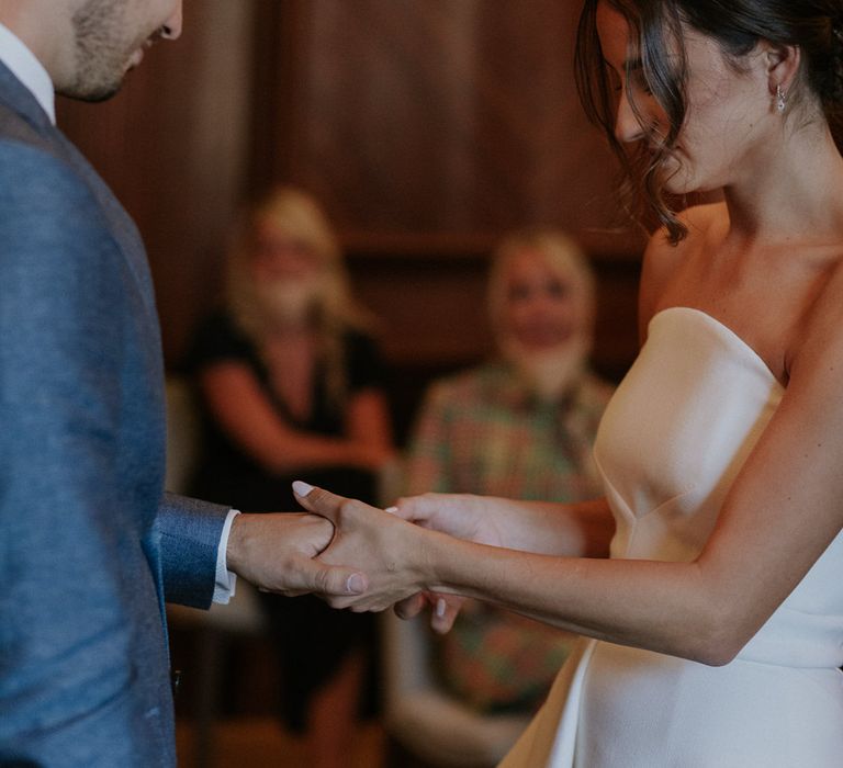 Bride and groom exchanging rings at socially distanced micro wedding