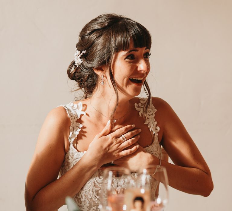 Bride smiling during wedding speeches 