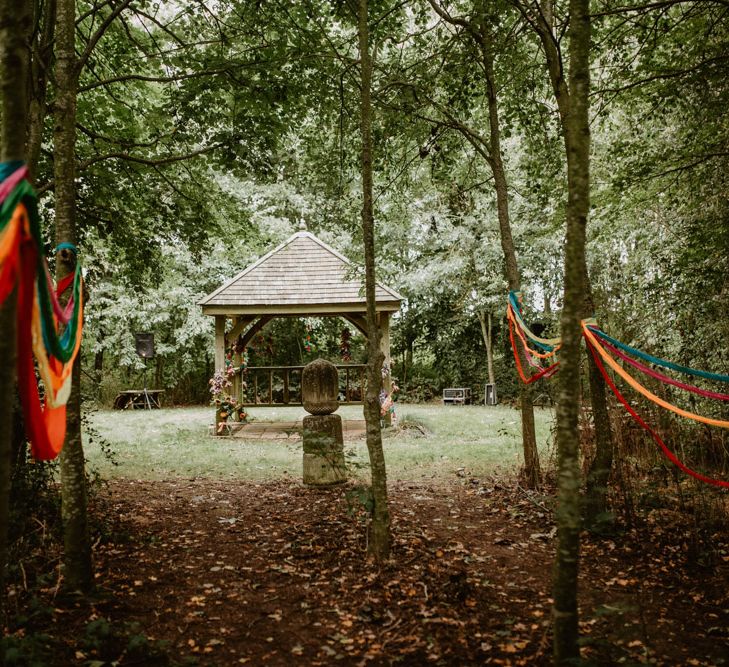 outdoor wedding ceremony with streamer aisle 