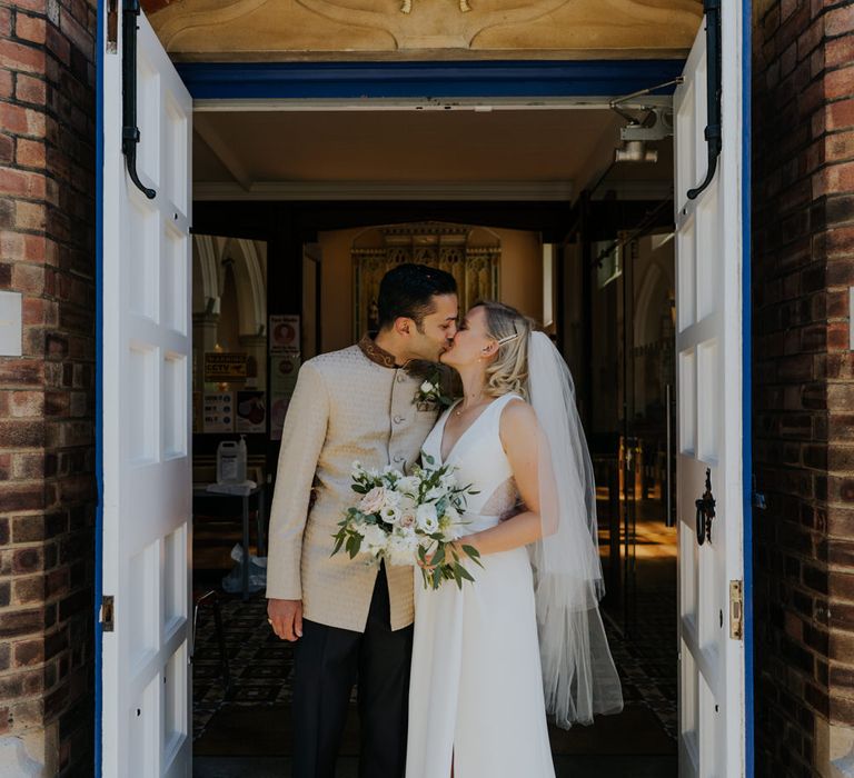 Bride and groom kissing at micro wedding 