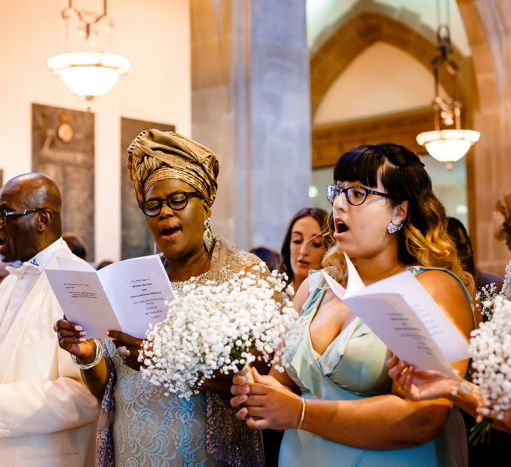 Mother and Father of the bride singing in the church 