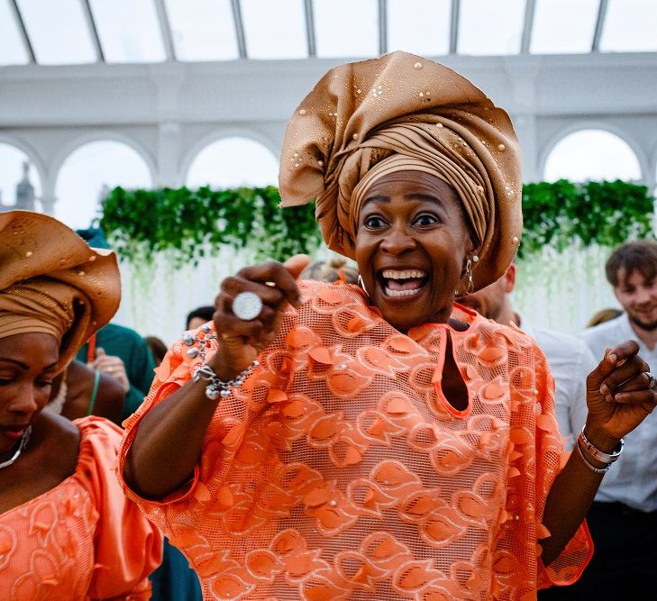 Wedding guests in Coral Nigerian Outfits 