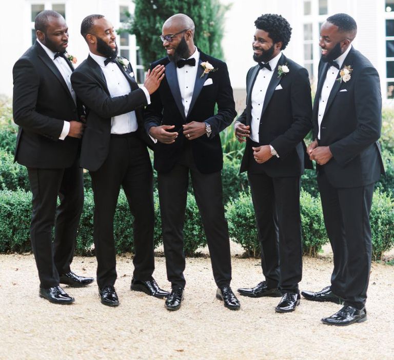 Grooms laughing in smart black-tie 