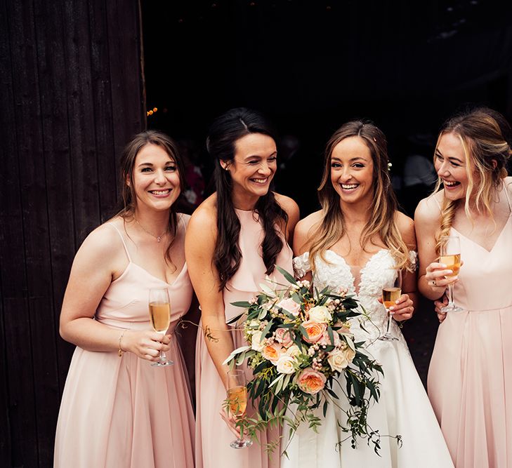 Bridal party with bridesmaids wearing Peach bridesmaids dresses 