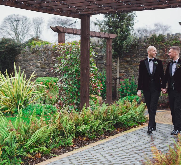 LGBTQ+ couple holding hands at their Darver Castle wedding 