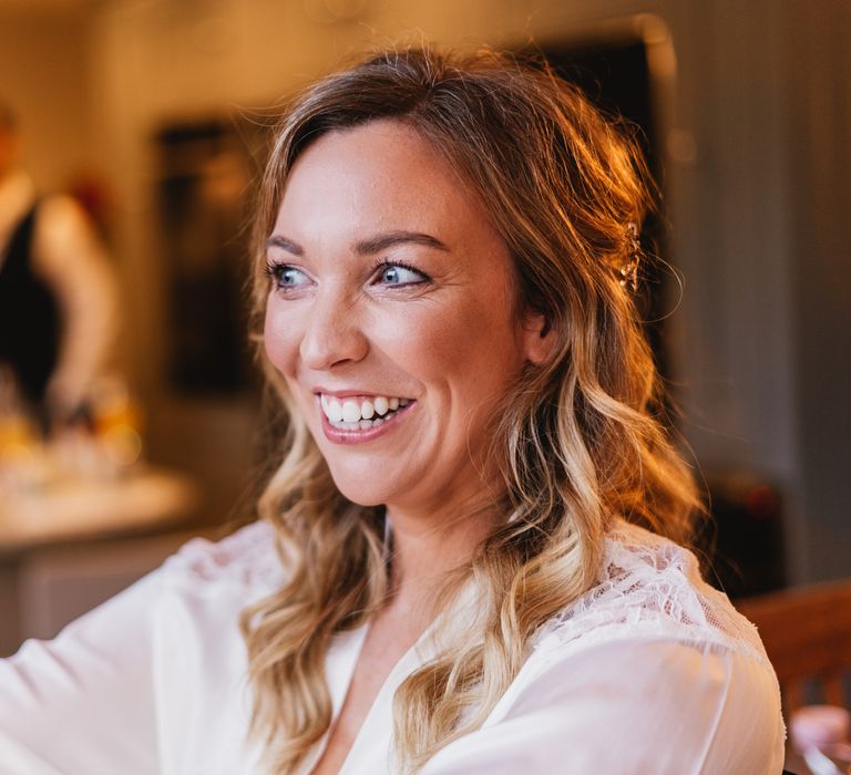 Bride smiles and laughs on the morning of her wedding