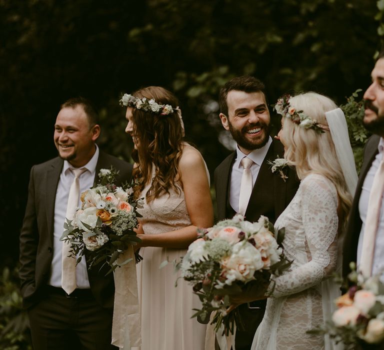 Bride in Grace Loves Lace wedding dress and single tier cathedral length veil stands with groom in black Hugo Boss suit and groomsmen and bridesmaids at Drenagh Estate Wedding