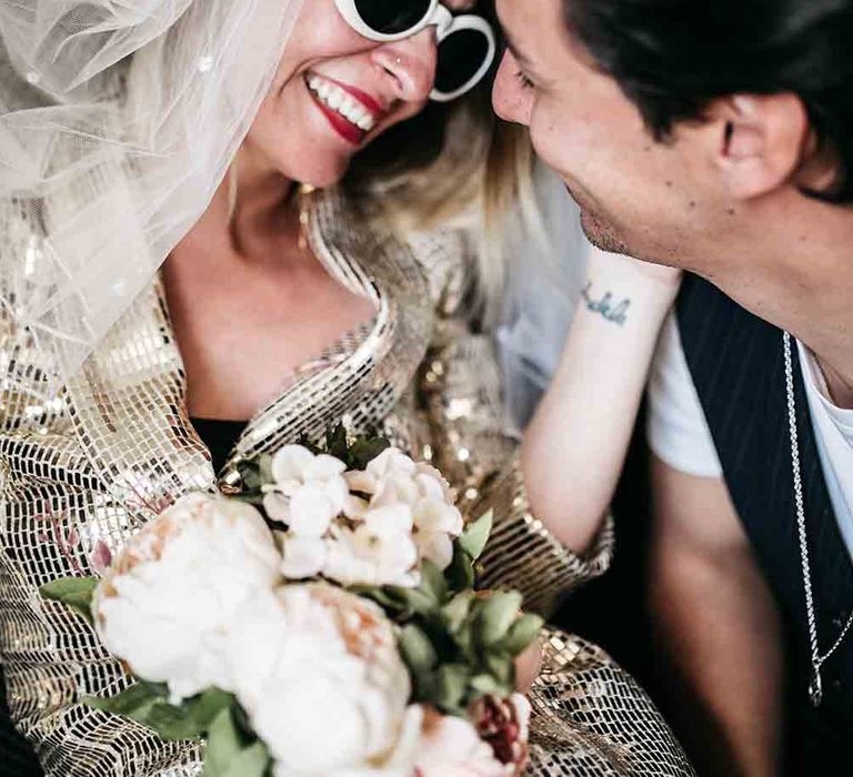 Bride wears white sunglasses and red lipstick for Las Vegas wedding