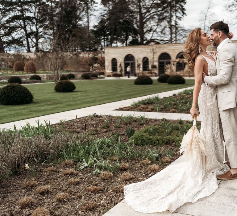 Bride and groom portrait in the gardens at Middleton Lodge with The Fig House in the background