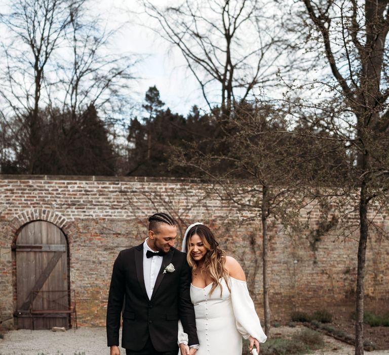 Beautiful bride in an off the shoulder wedding dress with front button detail 