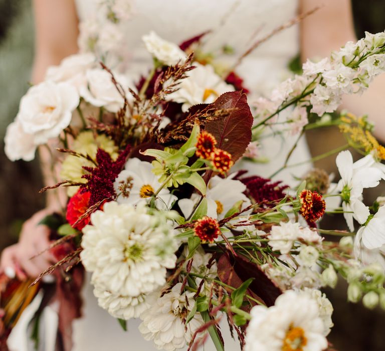 Bouquet of wild white roses, gerberas, dahlias and wild grasses