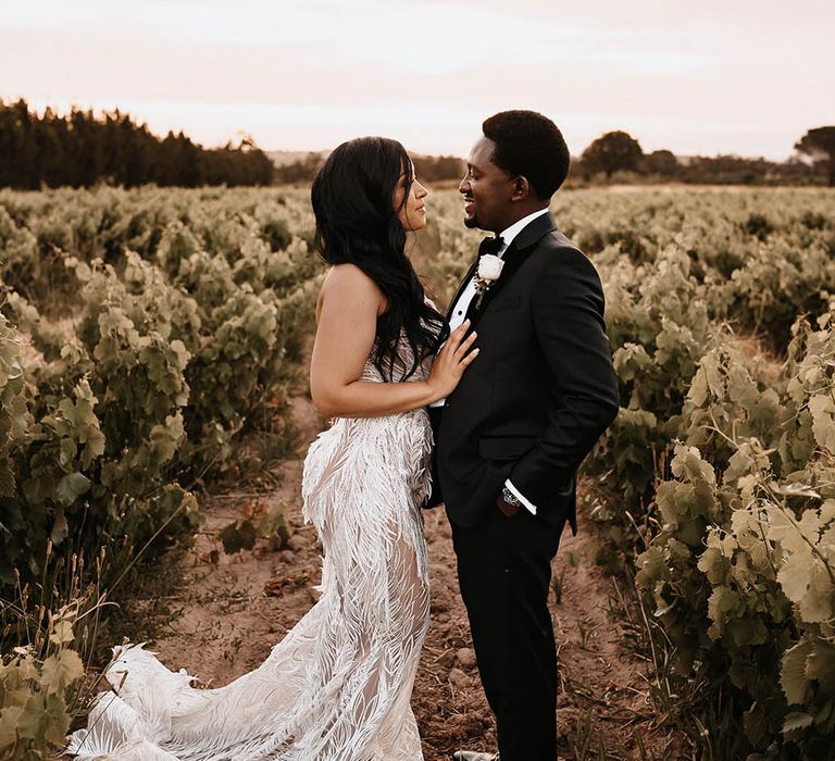 Intimate ride and groom portrait in a field 