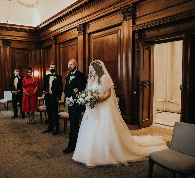 Bride enters the room during wedding ceremony