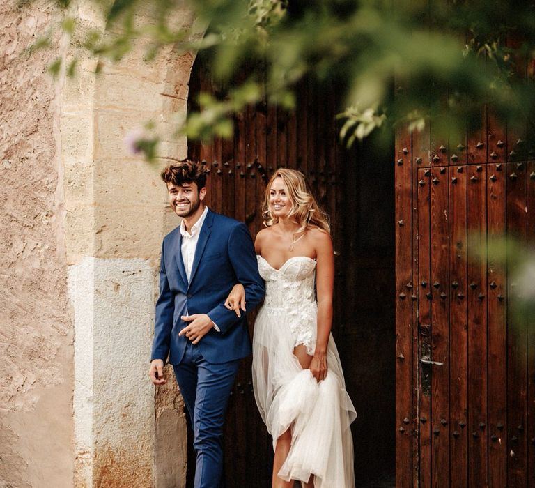 Bride and groom arm in arm at Finca Biniagual in Spain