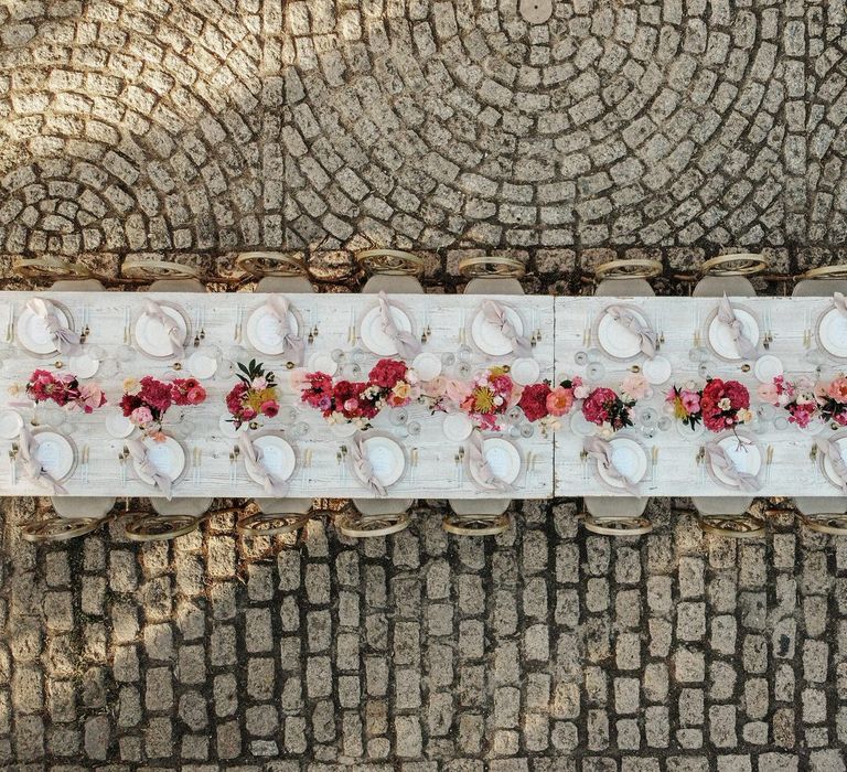 Finca wedding in Spain with white and pink banquet table at Finca Biniagual