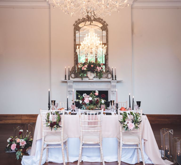 Intimate wedding reception decor at Thicket Priory country house with black, pink, white and red colour scheme 