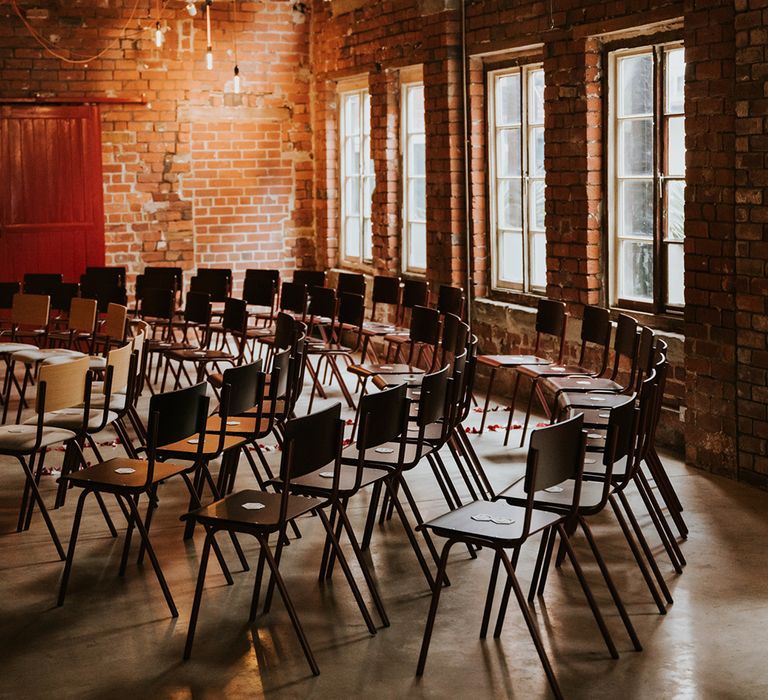 Rows of seats are set out in a semi circle for a wedding ceremony.