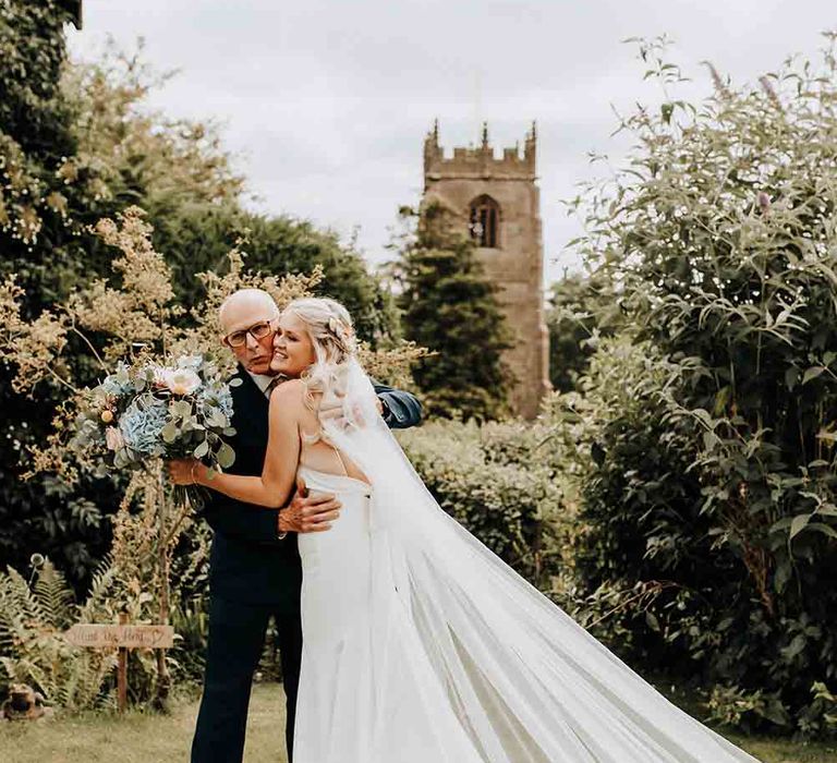 Bride in Allure Bridal gown and cathedral length veil