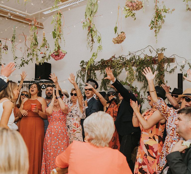 Wedding guests celebrate during beach wedding