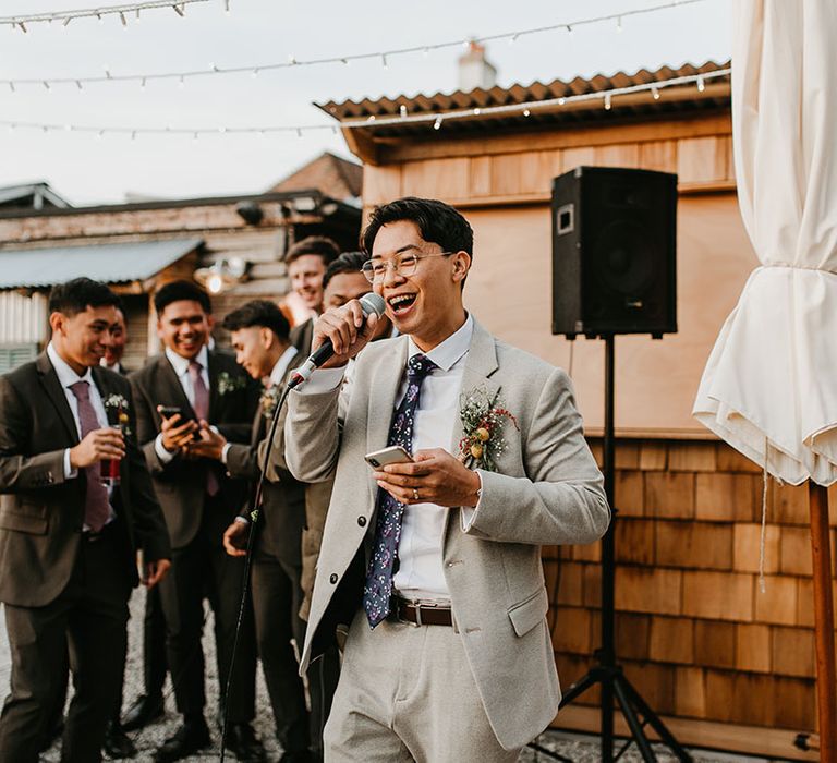 Groom gives speech on his wedding day as he wears homemade buttonhole