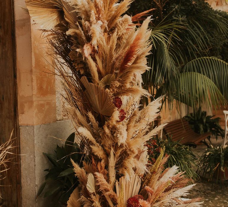 Pampas grass installation complete with bright florals throughout