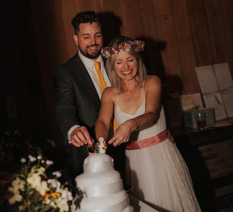 Bride and groom cut the wedding cake