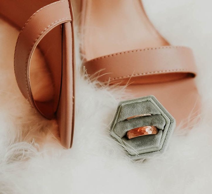 Velvet green wedding ring box with neutral sandals for bride